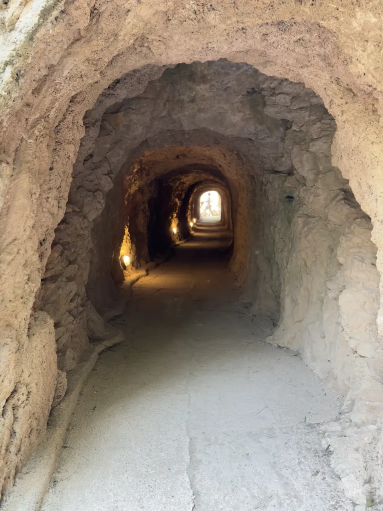 Sentiero scavato nella roccia che porta dentro una grotta del parco